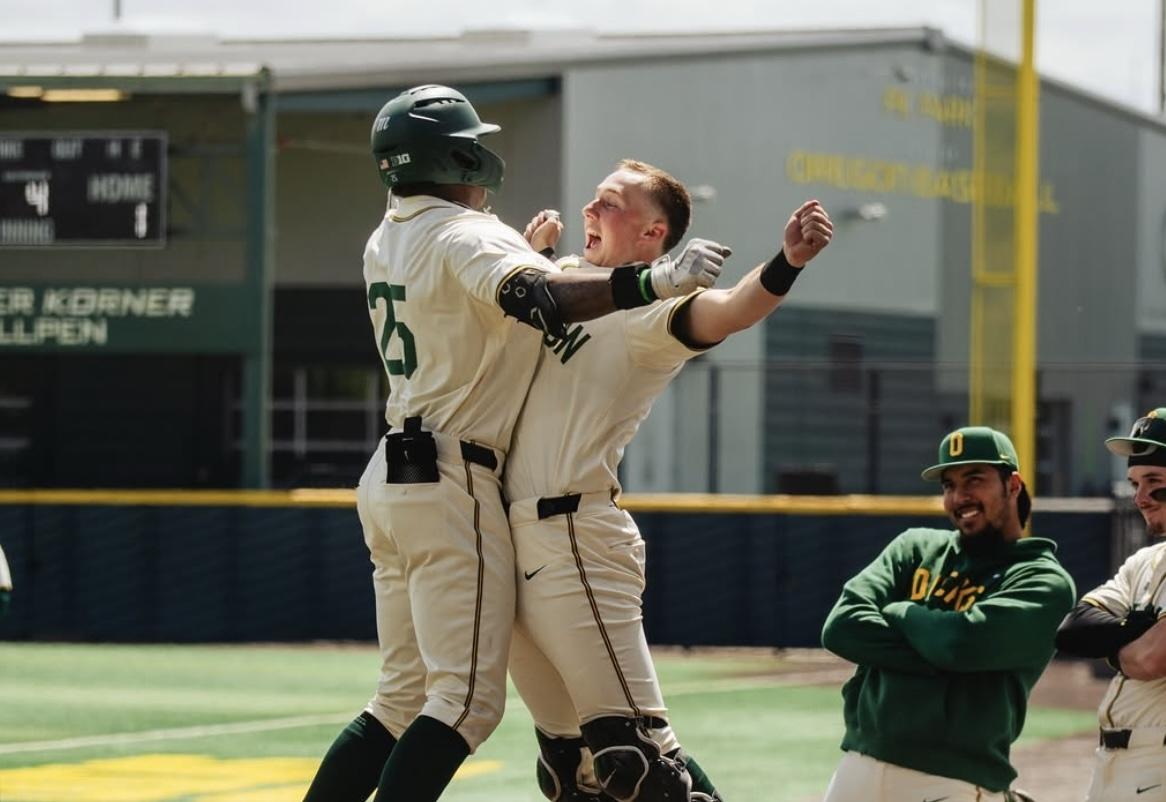 Oregon baseball players celebrate against Oregon State
